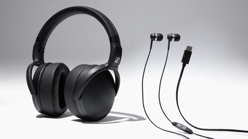 The Sennheiser HD 400U over-ear headphones and CX 80U earbuds alongside a USB-C cable on a grey background.