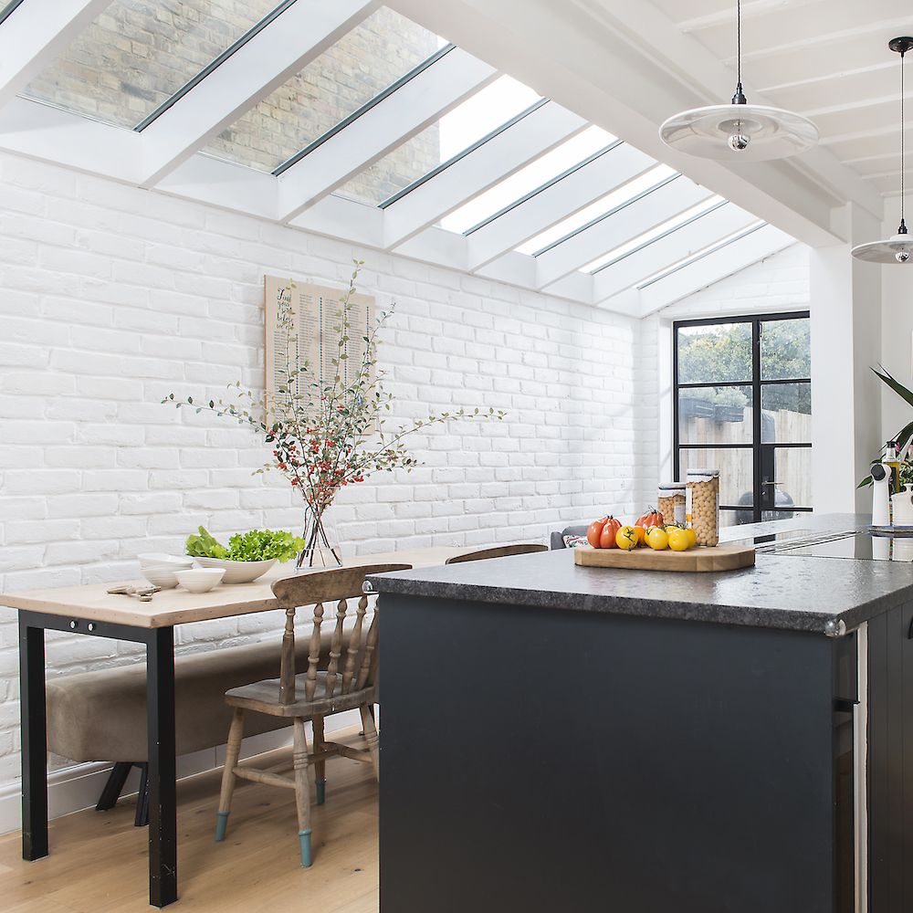kitchen room with wooden chair white wall and fruits tray