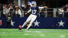 Brandon Aubrey of the Dallas Cowboys kicks off during an NFL football game