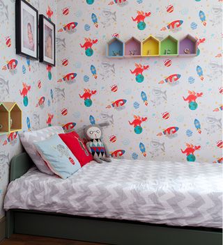 boys bedroom with rocket wallpaper on wall