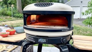 Gozney Arc pizza oven shown outside in a backyard