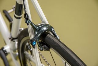 Detail of Ribble Endurance 725 road bike showing rim brakes and tire clearance