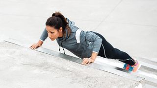 a photo of a woman doing an incline push up