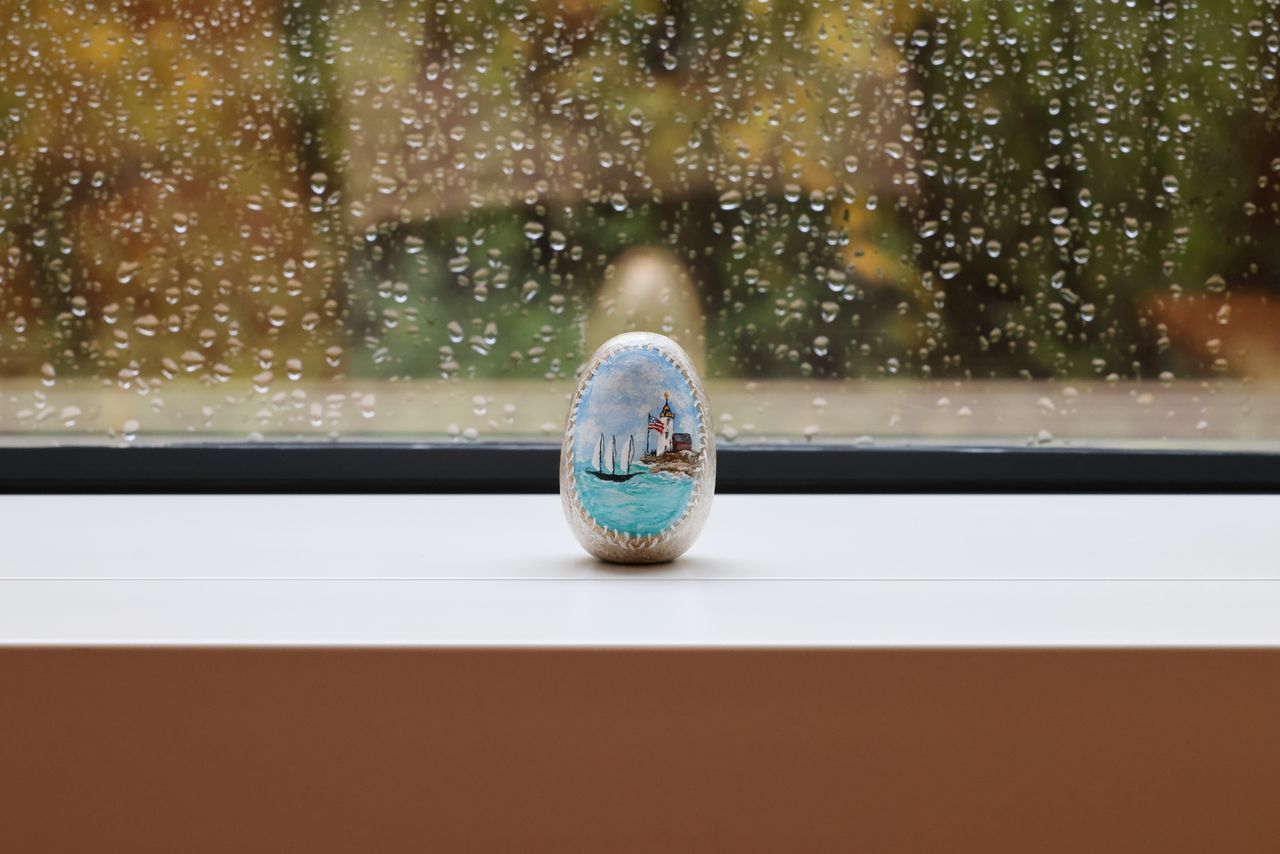 Painted stone in front of a window
