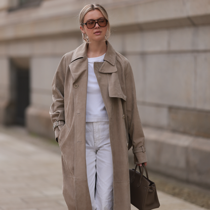  Isabelle Hartmann seen wearing Corlin Eyewear brown sunglasses, COS white cotton basic t-shirt, Max Mara beige suede leather oversized trenchcoat / long coat, Levi’s white vintage denim straight leg pants / jeans and Hermès Birkin 25 brown / taupe leather handbag on April 05, 2024 in Hamburg, Germany.