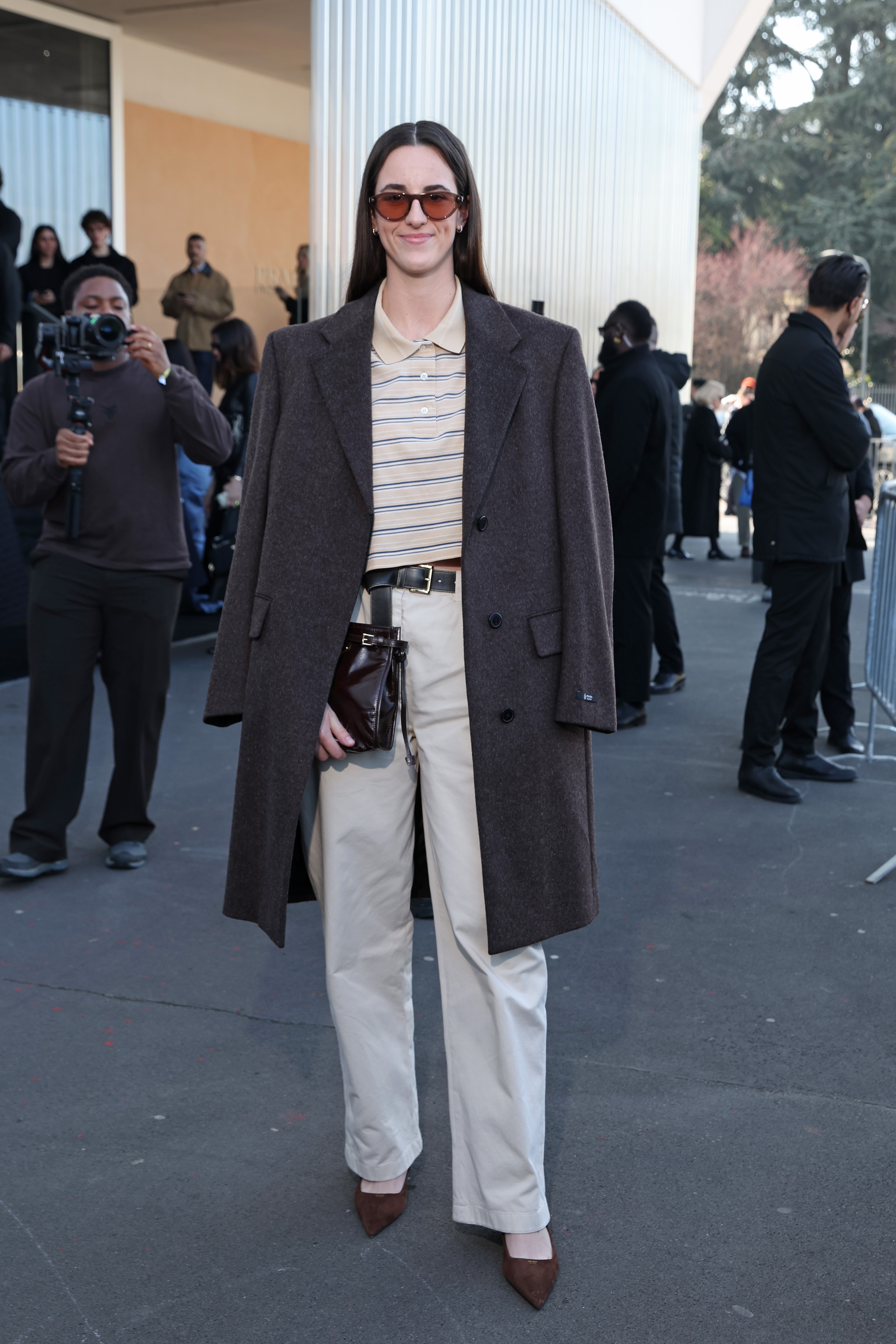 Caitlin Clark arriving at the 2026 Fall Prada fashion show wearing a cropped polo shirt