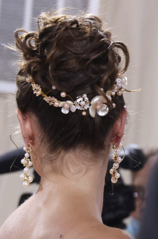 taylor hill with a flower crown at the met gala