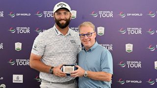 Jon Rahm is given a DP World Tour Honorary Life Membership card from CEO Keith Pelley