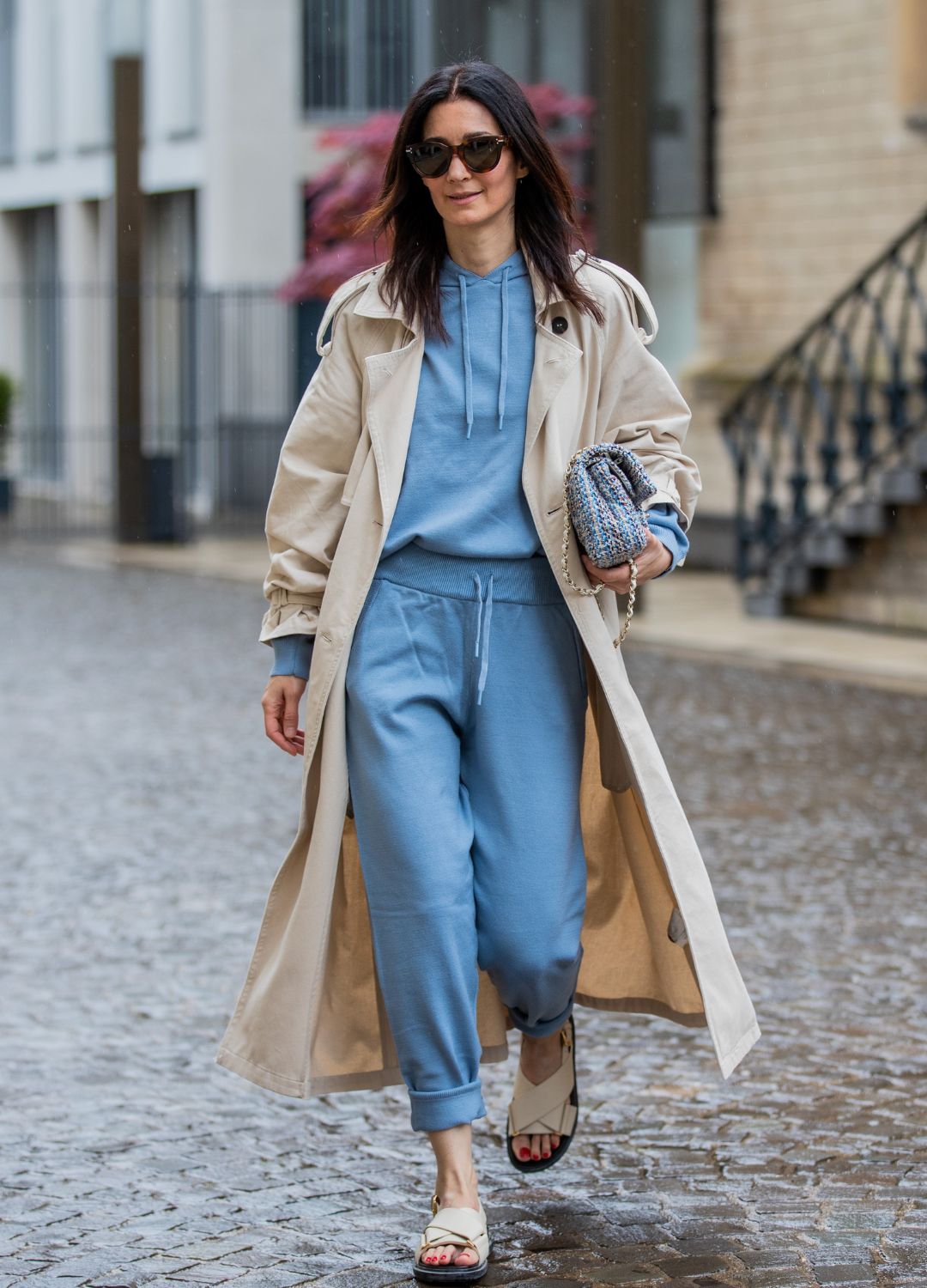 Golestaneh Mayer-Uellner is seen wearing jogging suit Zara, trenchcoat H&M, dad sandals Marni, tweed bag Chanel in blue, sunglasses Celine on May 21, 2021 in Cologne, Germany