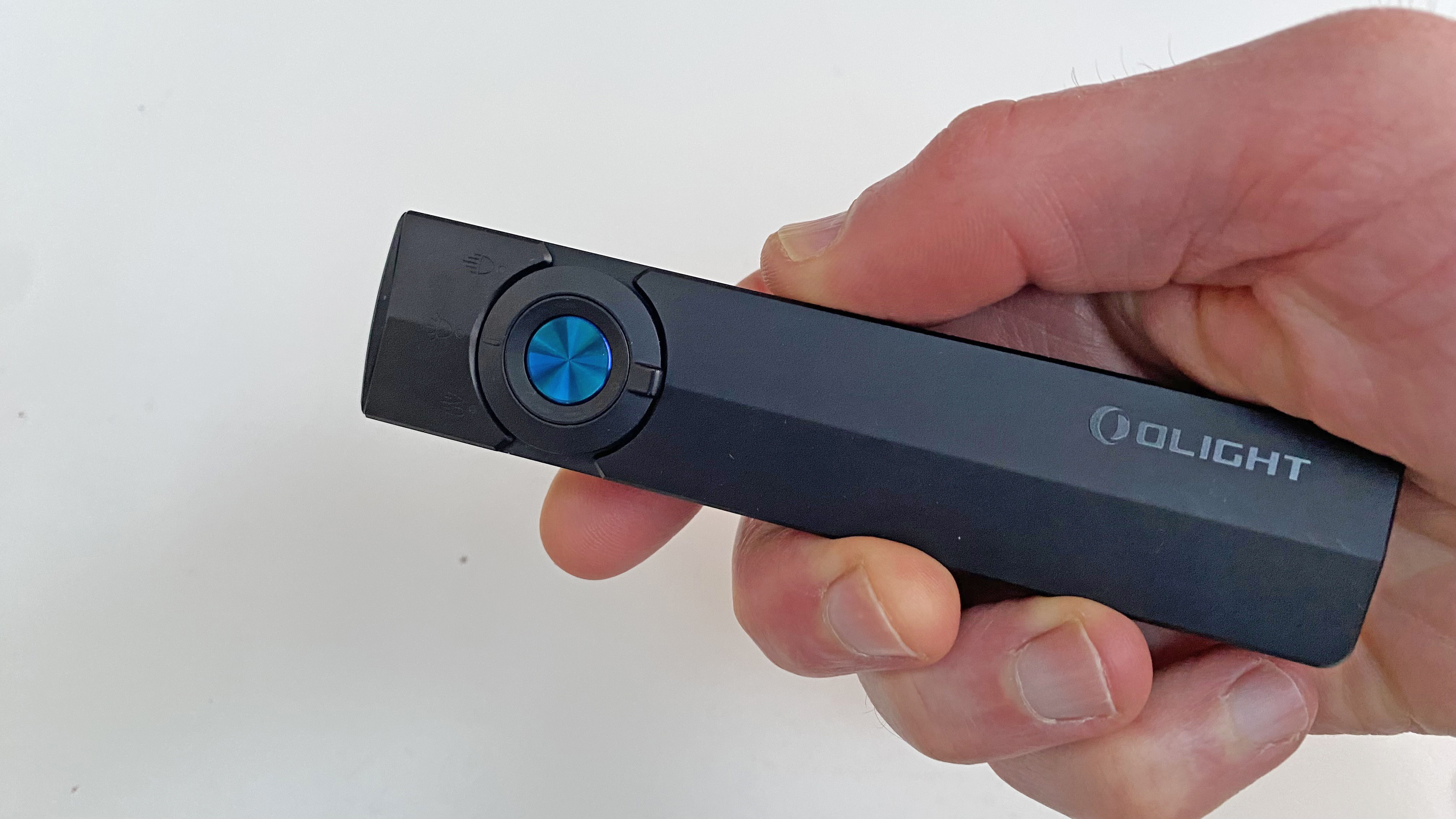 The Olight ArkPro Flashlight being held in the hand