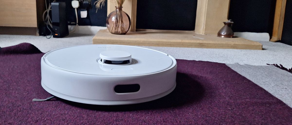 Dreame D9 Max Gen 2 robot vacuum in front of fireplace in reviewer&#039;s home