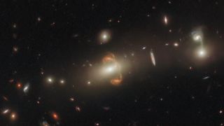 A galaxy captured through a gravitational lens appears like two mirror galaxies.