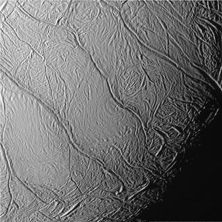An image captured by NASA's Cassini spacecraft shows Enceladus' "tiger stripes," the parallel faults scarring the moon's southern polar region.