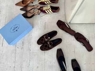 A scattered assortment of chic footwear, including on-trend women's Adidas sneakers, The Row and Sam Edelman slingback heels, Toteme flip-flops, and suede Gucci loafers.