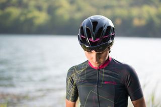 Elisa Longo-Borghini models the helmet and jersey from the collection