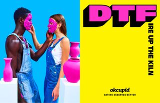View of an OKCupid ad with a half blue, half yellow background. On the blue side, there is a couple wearing dungarees, facing each other and touching each other's faces. Both of their faces are covered in purple clay and there are purple vases around them on white plinths. And on the yellow side, there is text that says 'DTFire Up The Kiln'