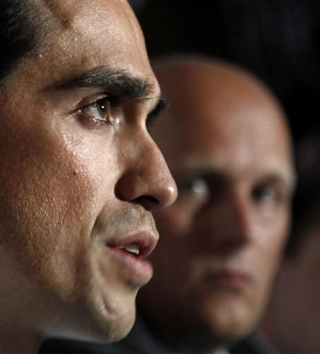 Alberto Contador, accompanied by team director Bjarne Riis, responds to questions about his doping sanction