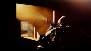 A marine uses his flashlight in a dark room
