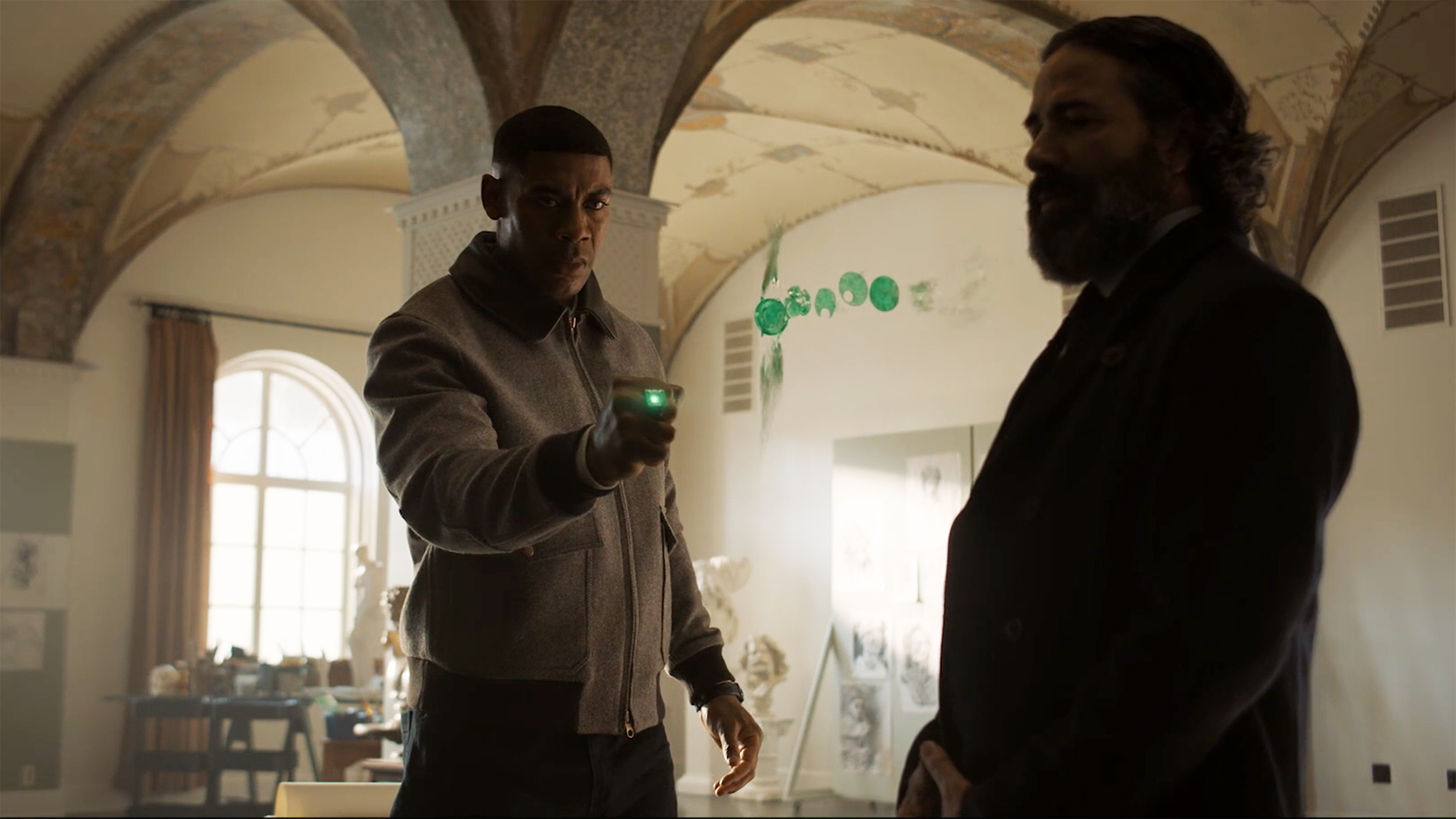John Stewart using a Green Lantern ring to construct his dad's watch as a Guardian of the Universe looks on in Lanterns episode 3
