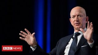 Jeff Bezos waving his hand