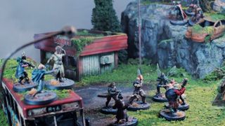 Zone Wars tabletop battle scene, with all factions locked in combat on a post-apocalyptic board