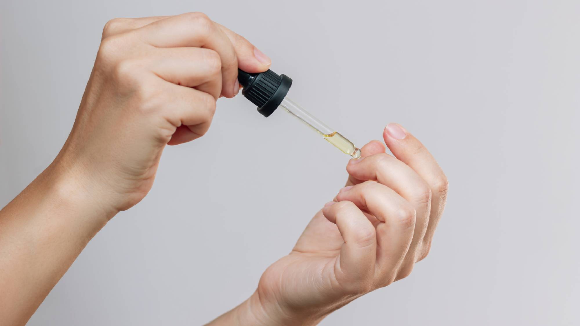 Applying jojoba oil to nails