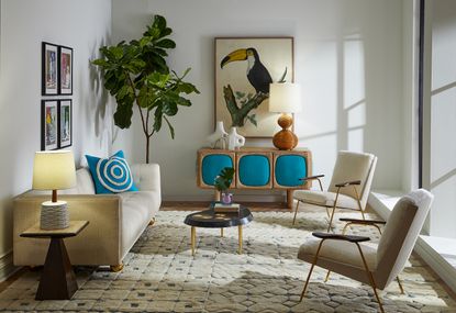 Neutral living room with touches of blue and a plant in the corner