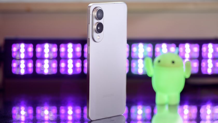 Samsung Galaxy S25 Edge from a 3/4 angle with black lights and an Android figuring blurred in the background