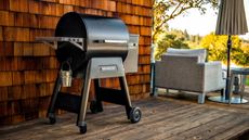 Best grills. Traeger grill on veranda, wooden floor, seating area in distance