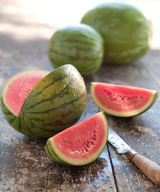 A ct up watermelon on a kitchen table