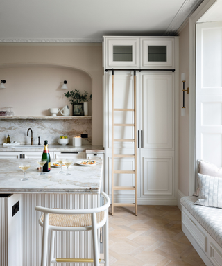 A white kitchen with a ladder