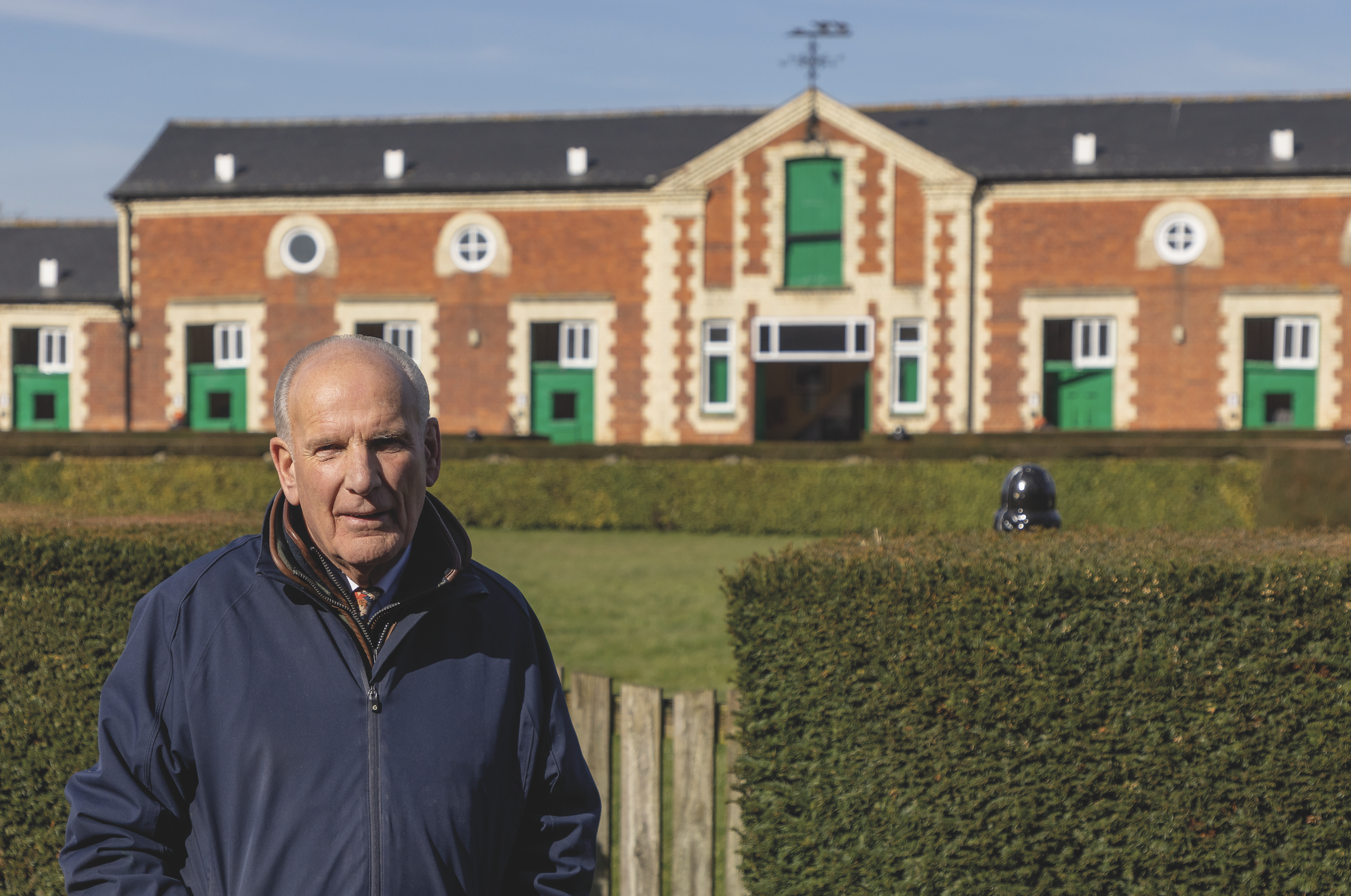 Sir Mark Prescott amid the precision-cut hedges, beautifully manicured lawns and spacious stables of Heath House Stables.