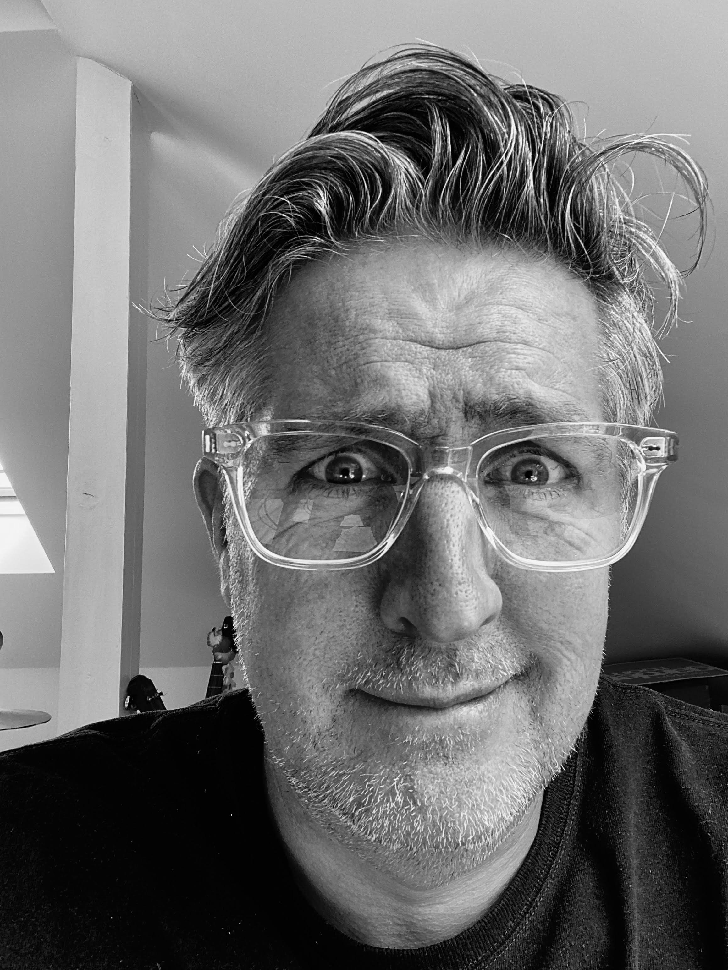 black and white photo of Steven Davis wearing glasses