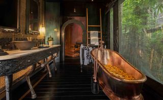 A bathroom room showing a large bath in The Lodge at Capella Ubud — Bali
