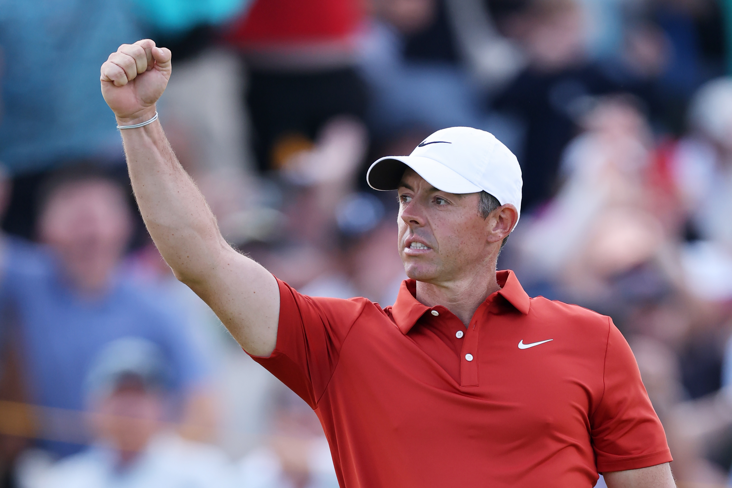 Rory McIlroy punches the air after holing a long-range eagle putt at the 12th during round three of the 2025 Open