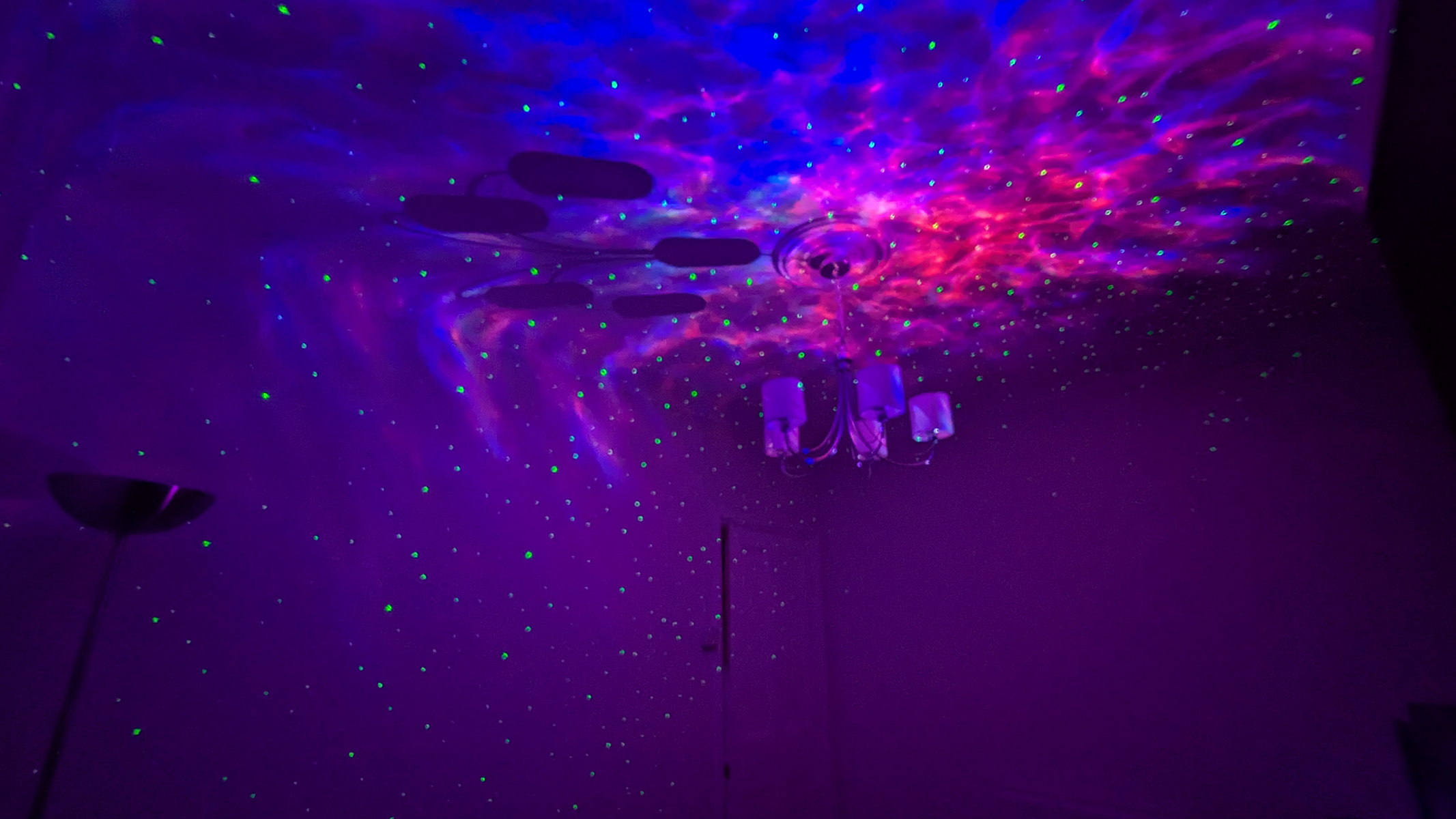 The Pikoy Galaxy Projector showing red and blue lights on the ceiling during review