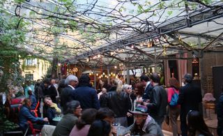The Spazio Rossana Orlandi courtyard with people socialising.