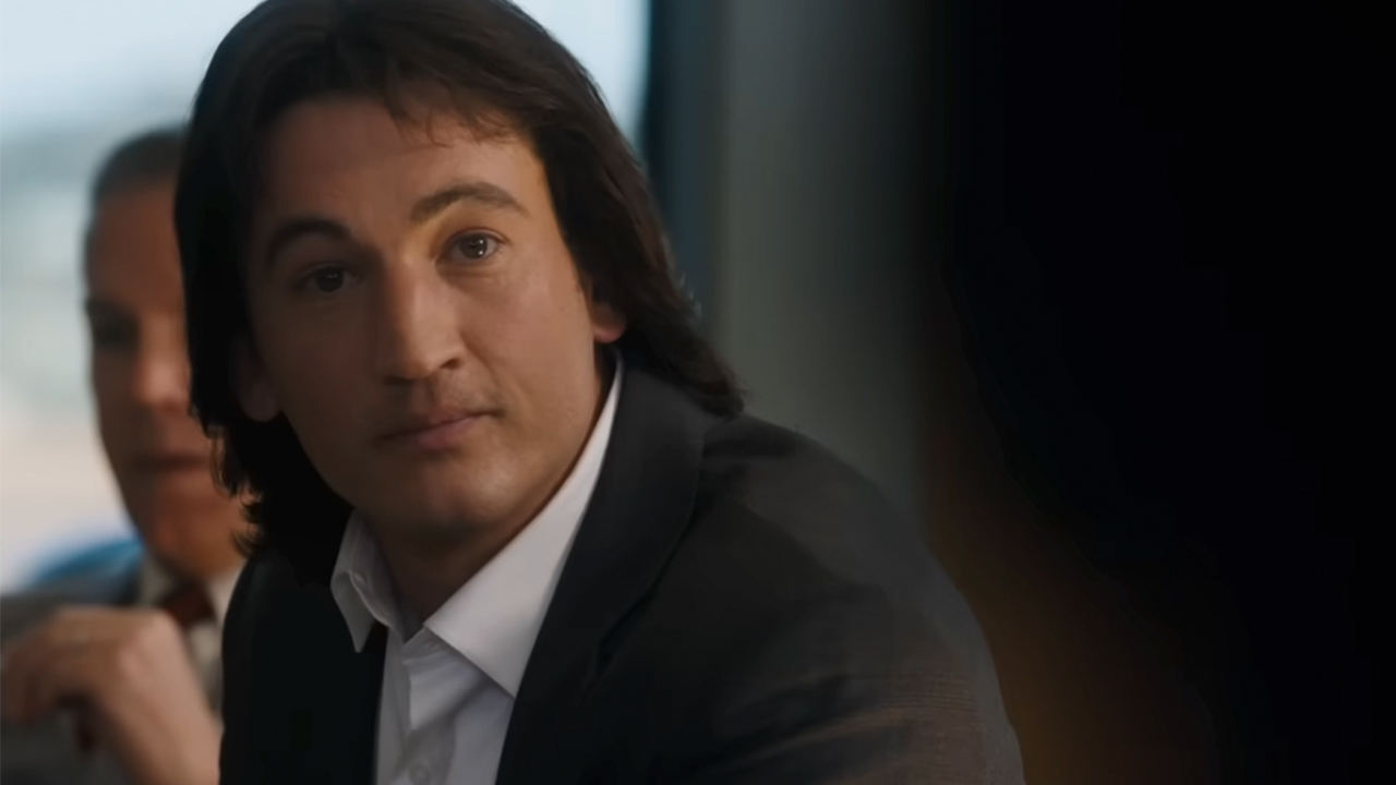 Miles Teller as John Branca, with long hair, in Michael