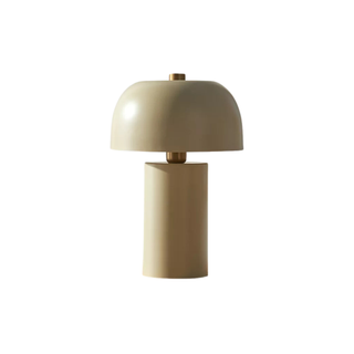 A cream colored mushroom table lamp with brass accents
