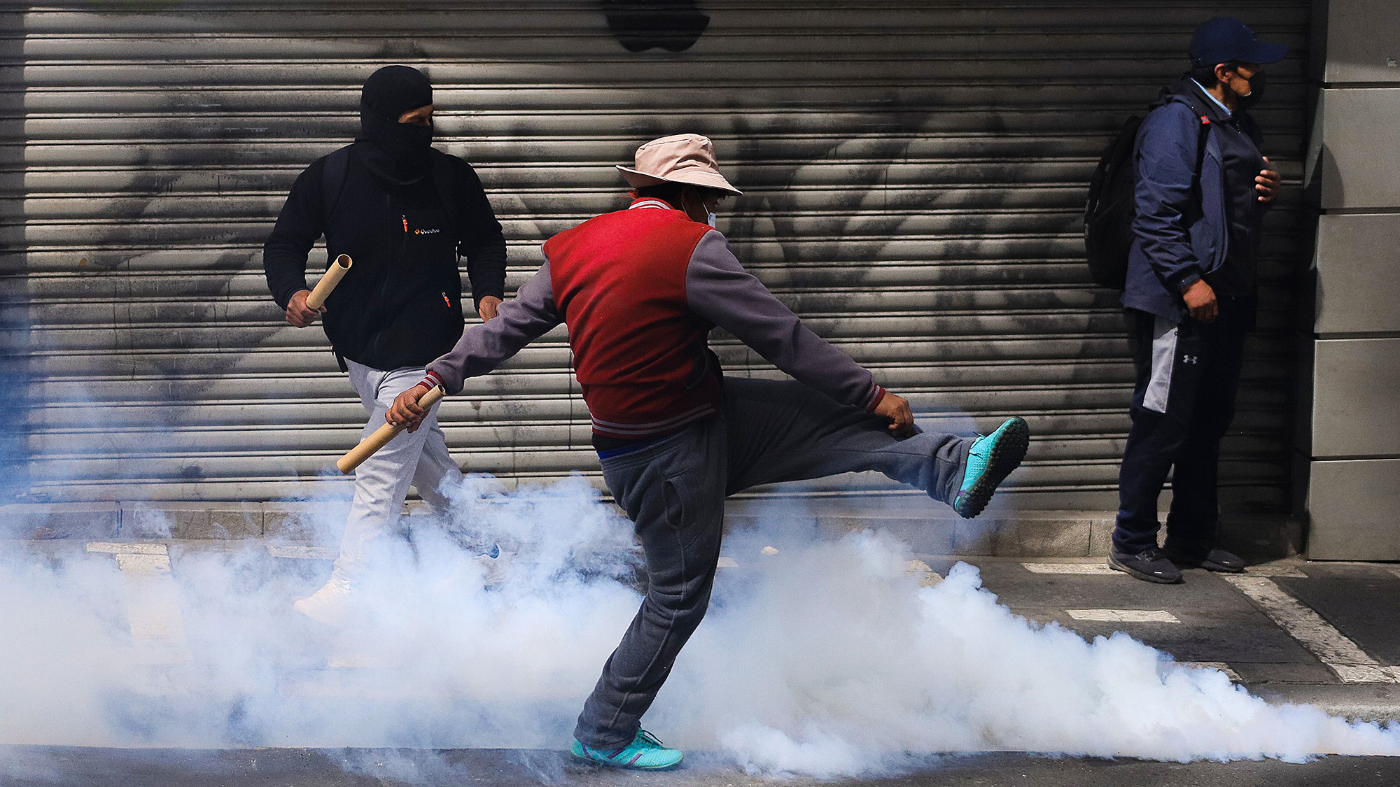 Protesters clash with police during a protest demanding the resignation of President Rodrigo Paz in La Paz, Bolivia