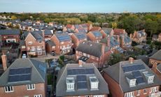 Aerial view of new modern housing with solar panels installed on rooftops