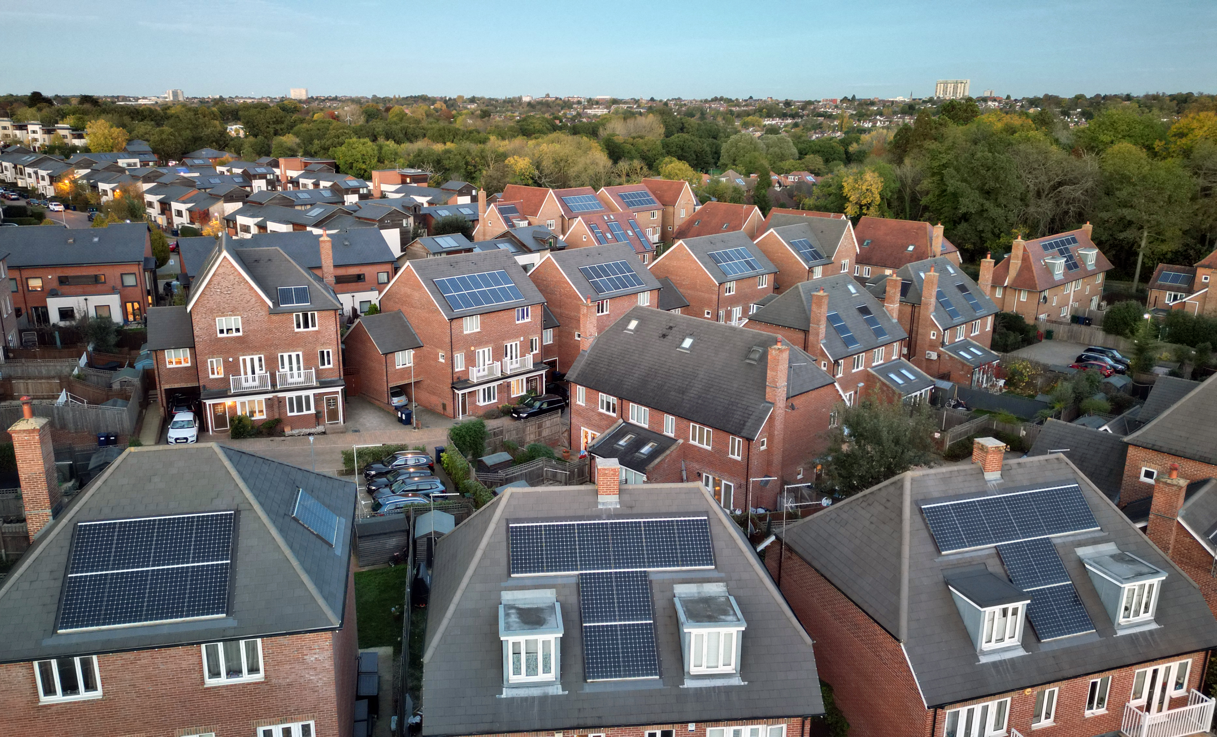 Aerial view of new modern housing with solar panels installed on rooftops
