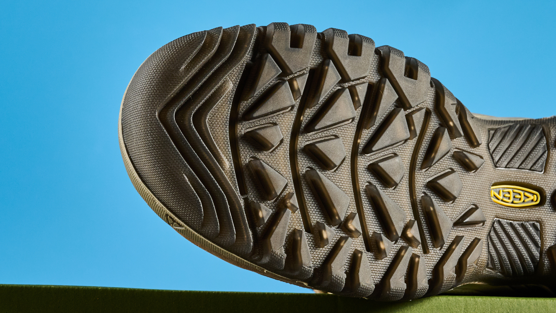 Keen Targhee IV hiking boots photographed in front of a blue background.