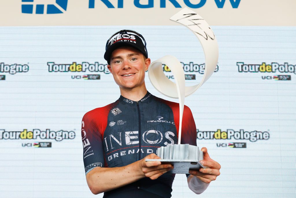KRAKOW POLAND AUGUST 05 Ben Tulett of The United Kingdom and Team INEOS Grenadiers celebrates winning the Bjorg Lambrecht memorial trophy on the podium ceremony after the 79th Tour de Pologne 2022 Stage 7 a 1778km stage from Valsir to Krakow TdP22 WorldTour on August 05 2022 in Krakow Poland Photo by Bas CzerwinskiGetty Images