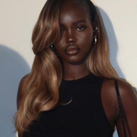 Adut Akech with shiny honey-blonde hair.