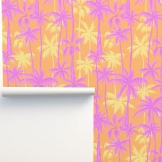 A bright yellow, orange, and pink palm tree printed wallpaper