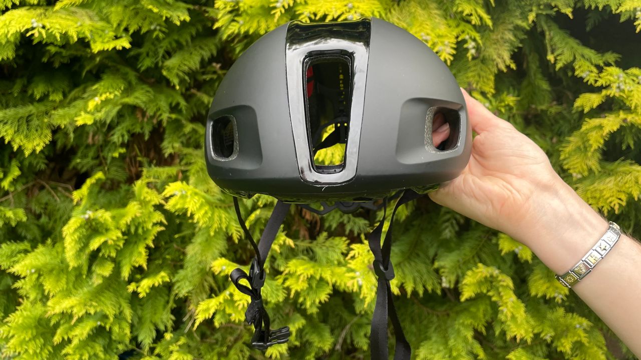 Female cyclist holding the Trek Ballista MIPS road bike helmet