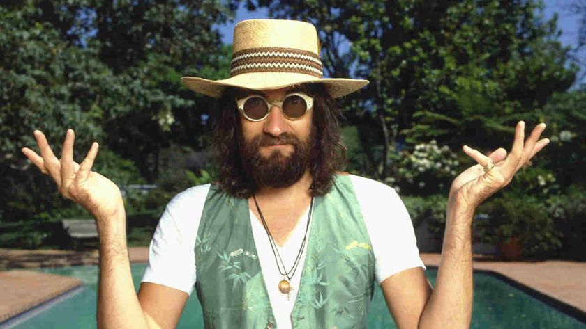 Mick Fleetwood sitting cross legged by a swimming pool in 1980