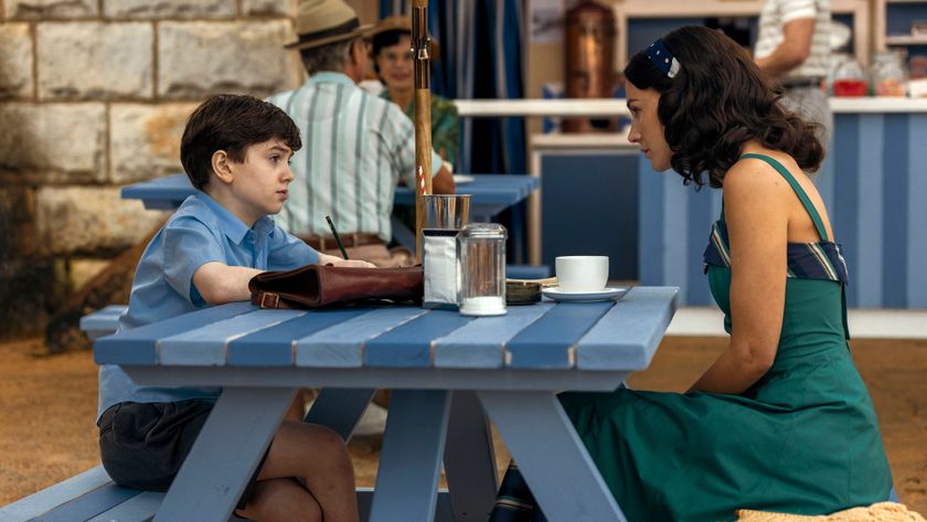 Kate in a green sundress eating ice cream on a bench with Michael