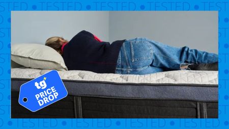 The image shows a light-haired mattress tester lying on the white and dark blue Helix Midnight Luxe mattress. Overlaid on top is a blue 'Tom's Guide price drop' label.